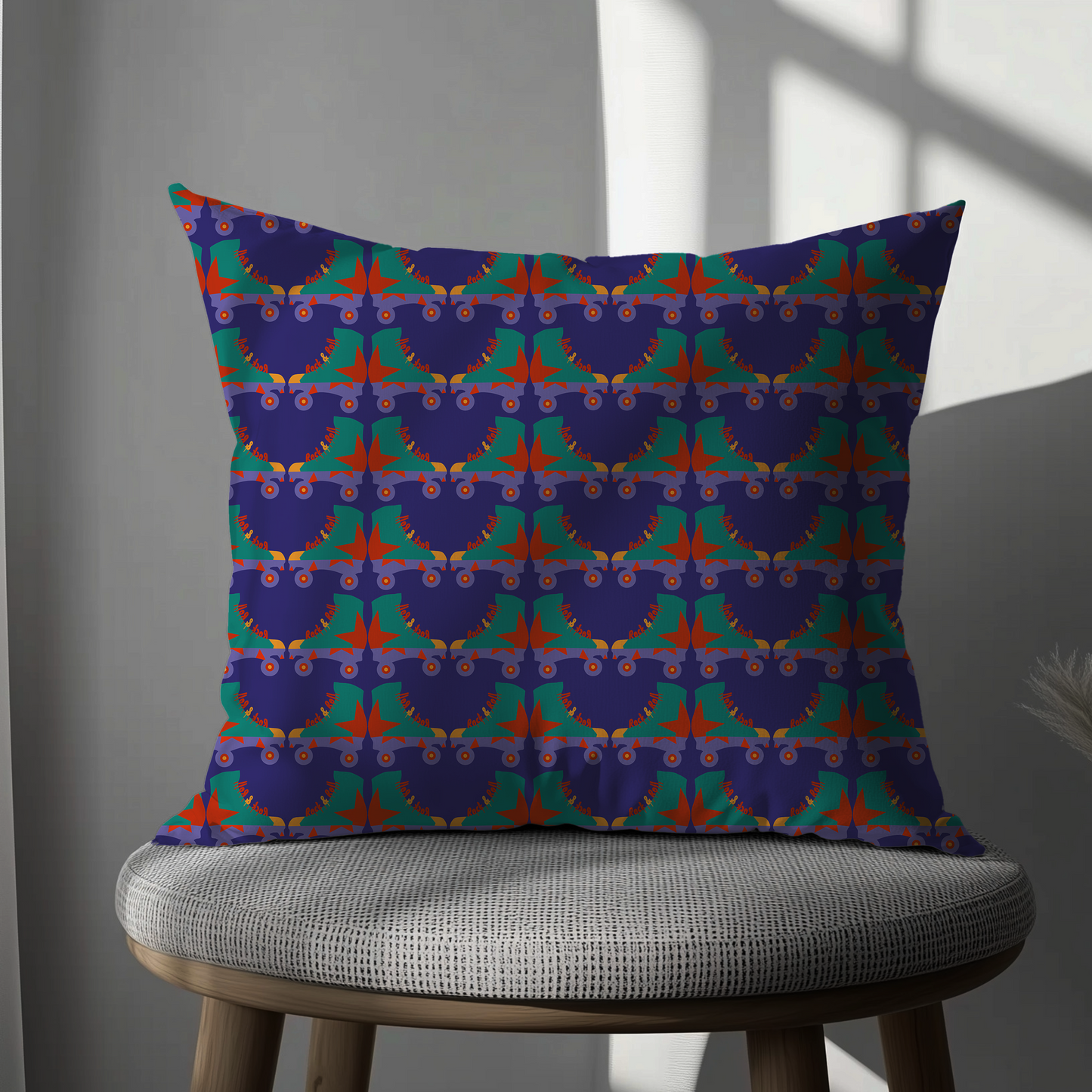 Decorative pillow with a colorful geometric pattern on a gray chair.