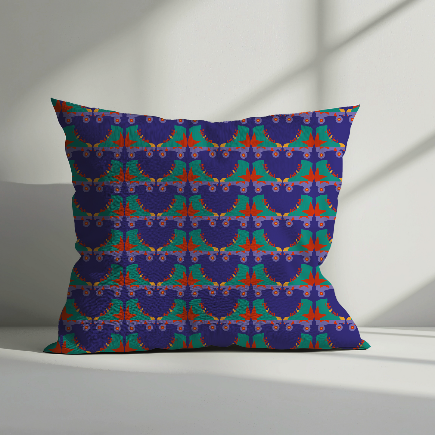 Decorative pillow with a colourful geometric roller skate pattern on a plain background