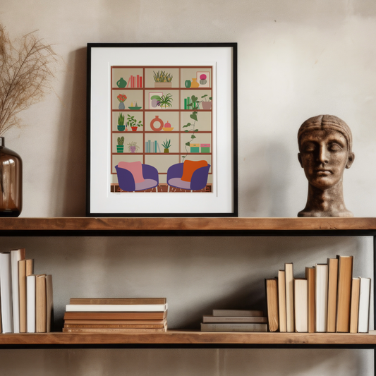 Stylish framed wall art print featuring a cosy reading nook with bookshelves, plants, and modern chairs, elegantly displayed on a wooden shelf with books and décor.