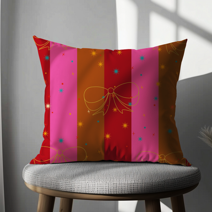 Decorative pillow with colorful stripes and bows on a gray chair.