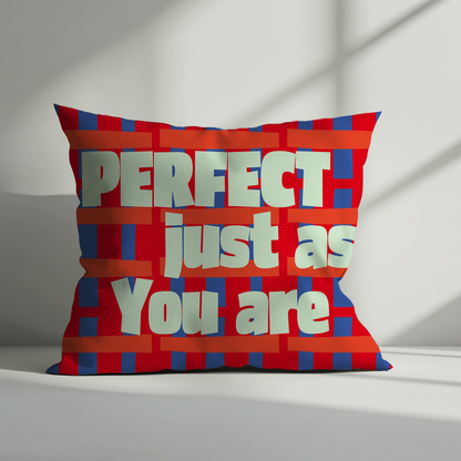 Red velvet cushion cover with bold white text saying “Perfect Just As You Are” on a vibrant red and blue geometric background, ideal for modern home décor.