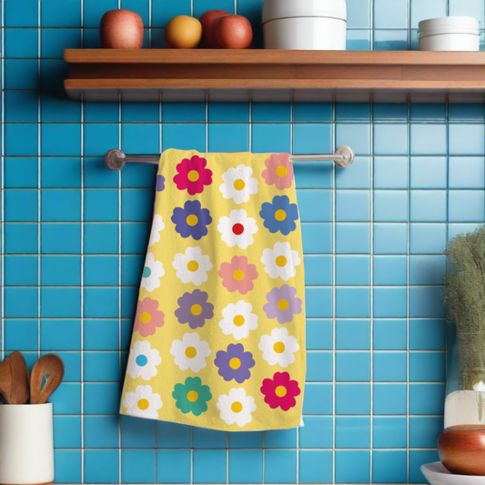 a daisy design kitchen towel Yellow in colour with multi coloured daisy flower design 
