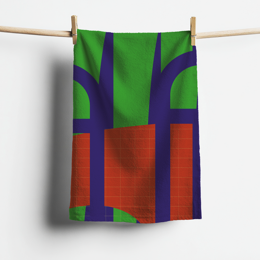 Colorful towel with abstract design hanging on a clothesline against a white background