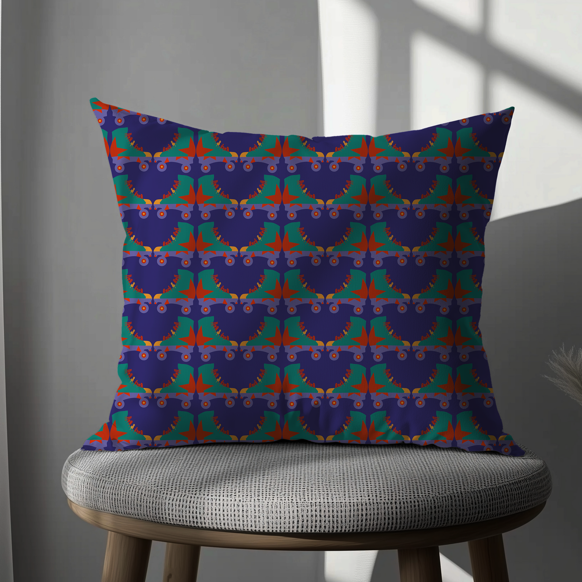 Decorative pillow with a colorful geometric pattern on a gray chair.