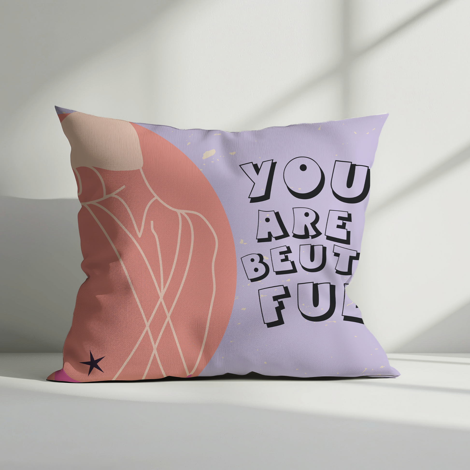 Decorative pillow with 'You Are Beautiful' text on a light background