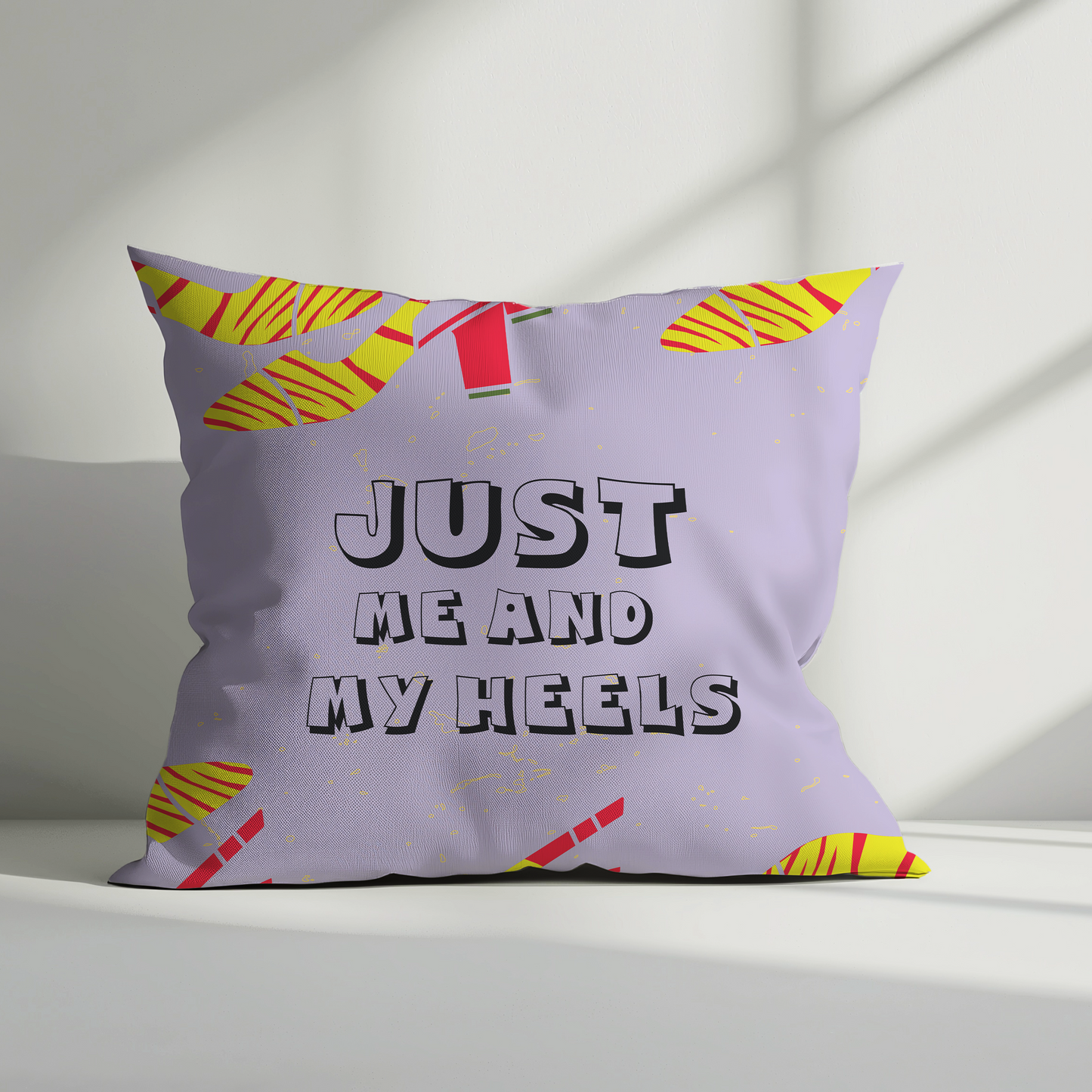 Decorative pillow with 'Just Me and My Heels' text on a light background
