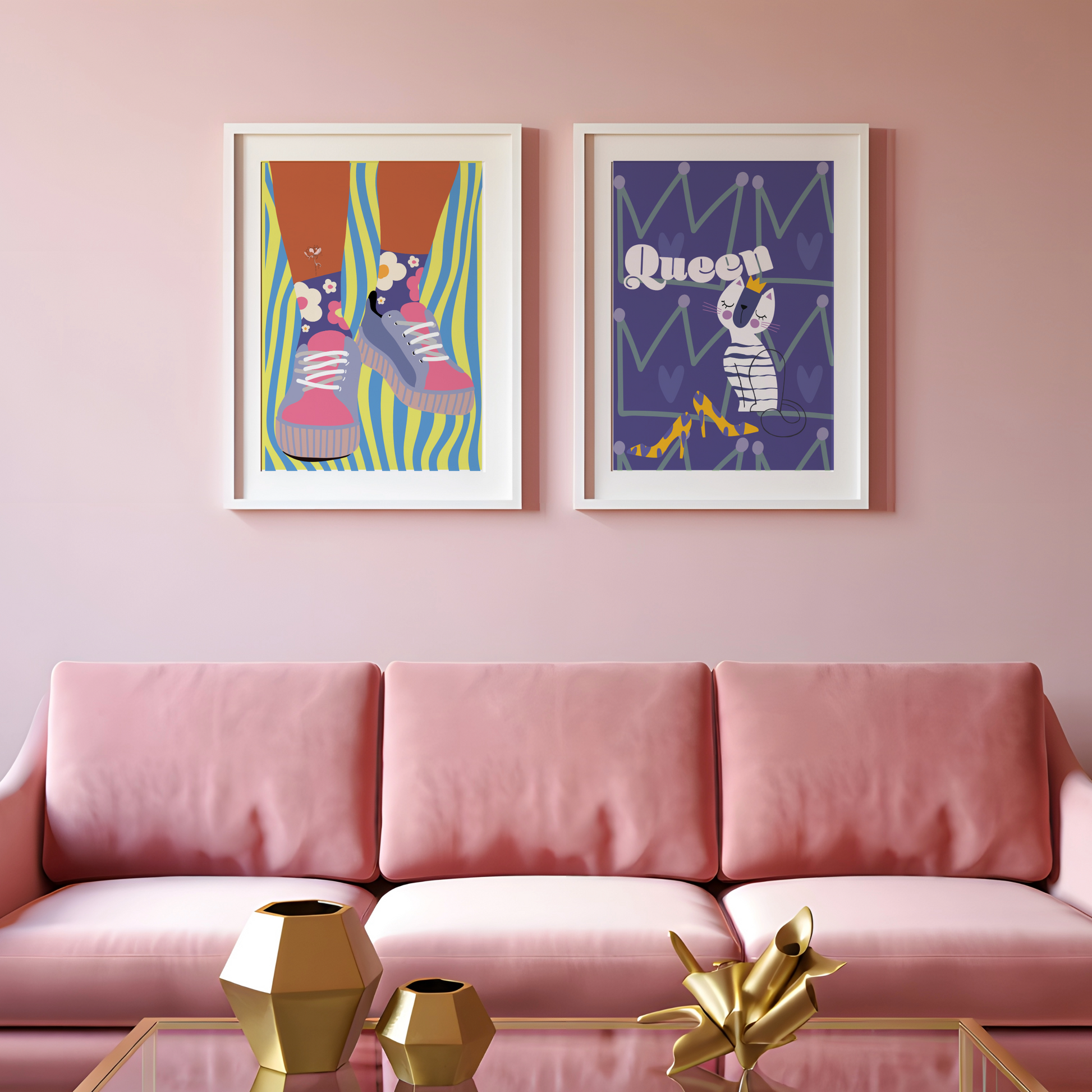Two framed artworks on a pink wall above a pink sofa with gold décor items.