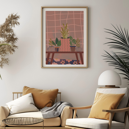 A framed art print featuring a stylized illustration of potted plants on a table against a pink grid background, displayed on a light gray wall above a beige sofa with mustard and white pillows in a modern living room setting.