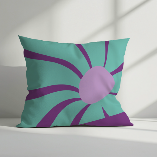 Retro floral cushion cover with turquoise background, purple flower petals, and a lilac center styled in natural light.