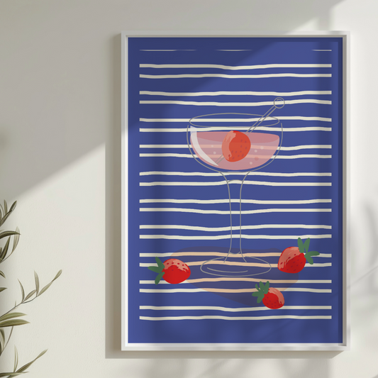 Framed artwork with a cocktail and strawberry design on a blue and white striped background.